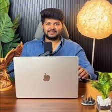 Munaaf analysing charts at his trading desk